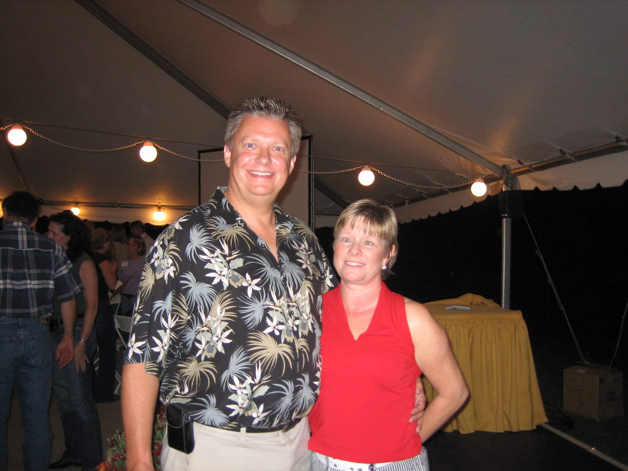 Susan and Rob Bowman smiling together at a tented event.