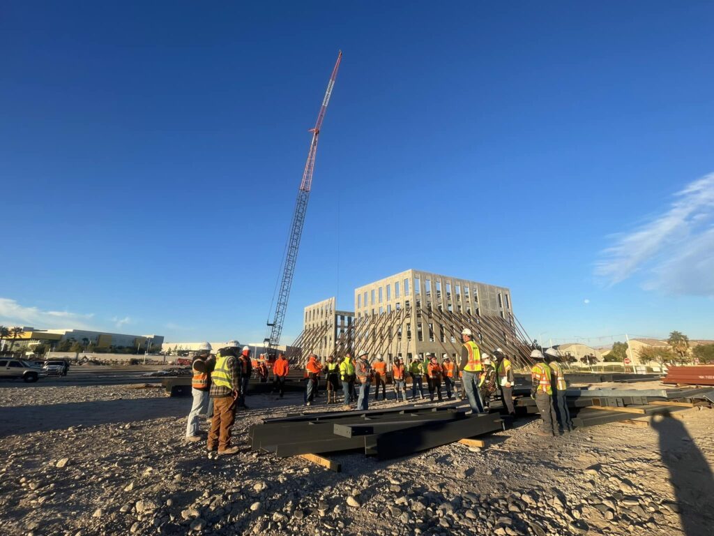 A construction crew gathers for a morning meeting on site.