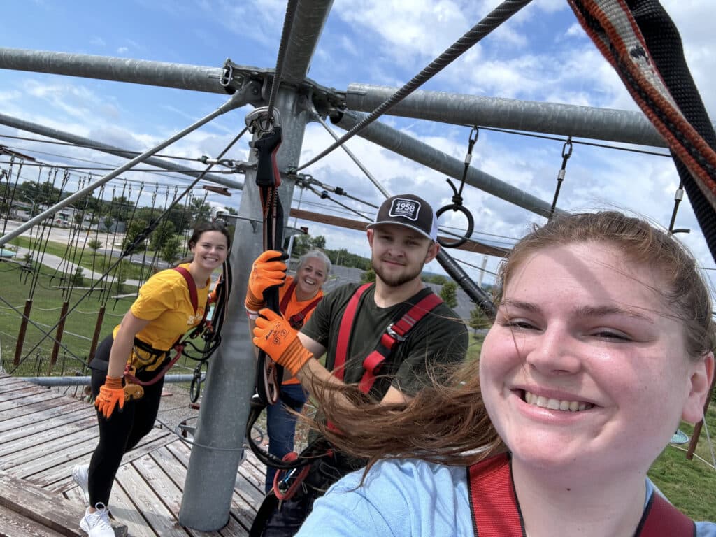 Elizabeth Vatole and her coworkers traverse a rope trail.