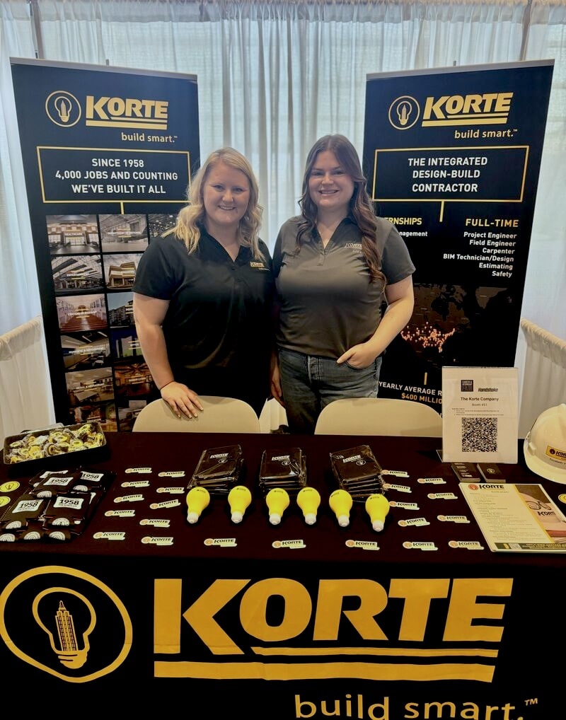 Elizabeth Vatole poses for a photo at a Korte Company booth.